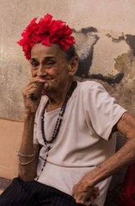 A Cuban lady smokes a cigar on the streets of Old Havana